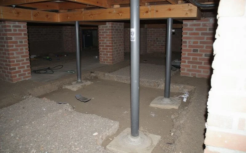 New drop girder and support posts installed under a subfloor